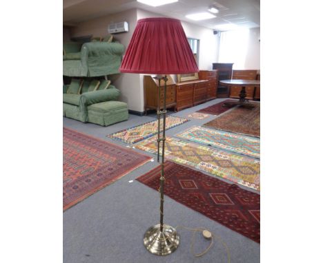 A contemporary brass rise and fall standard lamp with shade  