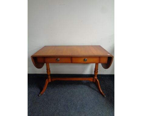 A yew wood drop leaf sofa table fitted two drawers 