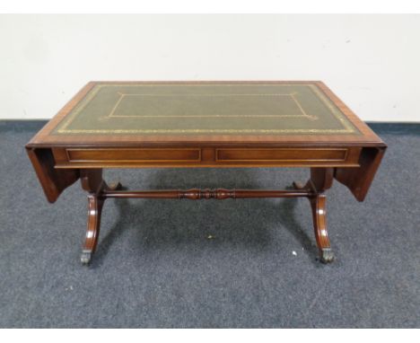 A mahogany flap sided sofa coffee table with a tooled green leather inset panel , 50 cm x 93 cm x 50 cm + extensions.