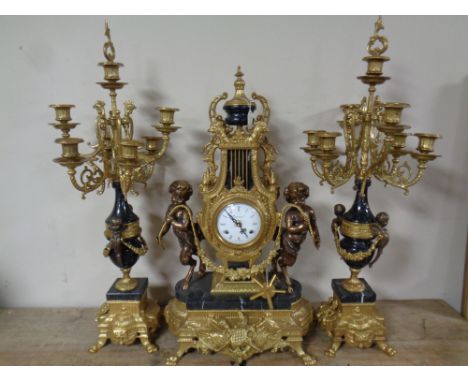 An impressive French brass and marble three piece imperial clock garniture  