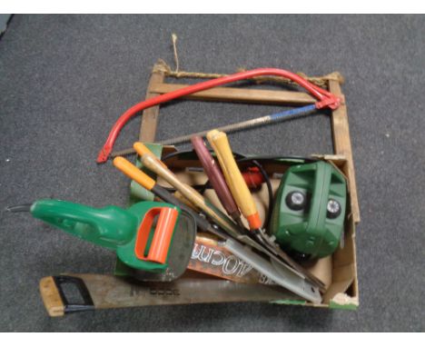 A box containing a Migatronic one 10V pump, electric hedge trimmer (continental wiring), assorted hand saws and tools  