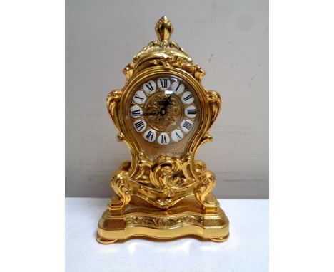A Swiss made Rococo style brass clock 