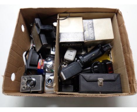 A box containing a quantity of vintage cameras and accessories to include Polaroid with boxed flash guns, Kodak boxed Brownie
