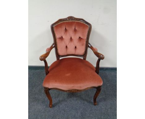 A stained beech French style salon armchair upholstered in a pink button dralon 