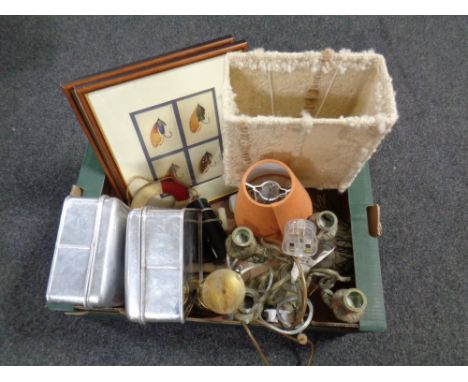 A box containing pair of framed prints, fishing flies, table lamps with shades, an antique brass lamp base, four way table ca