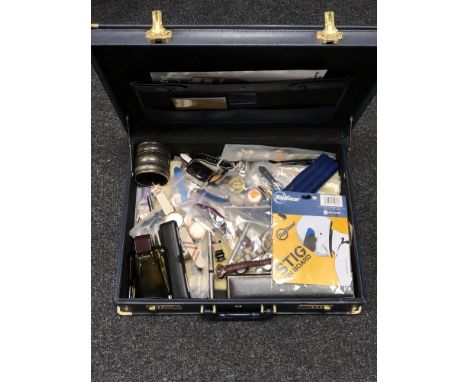 A briefcase containing modern wristwatches, two vintage silver-cased watch faces, pens, cuff bangle etc. 