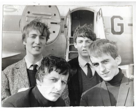 Original vintage photograph of The Beatles at Speke Airport, hand written on reverse “Beatles going to Germany early 62” and 