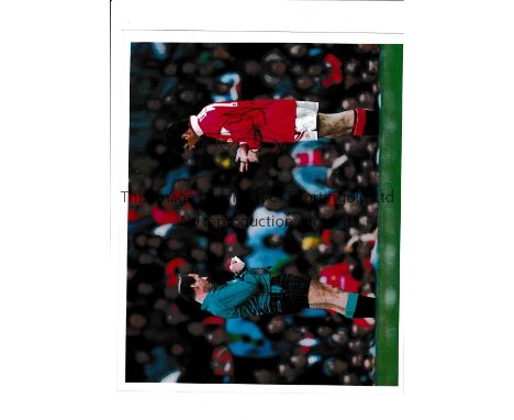 ERIC CANTONA AUTOGRAPH / MANCHESTER UNITED      A 10" X 8" colour Press photo with stamp on the reverse of Cantona being book