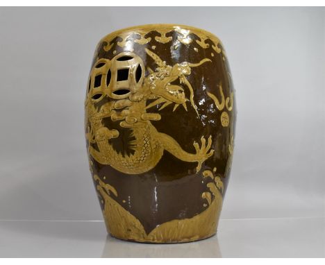 A Chinese Brown Glazed Garden Stea of Barrel Form decorated with Dragons, Pierced Sides, 44cms High 