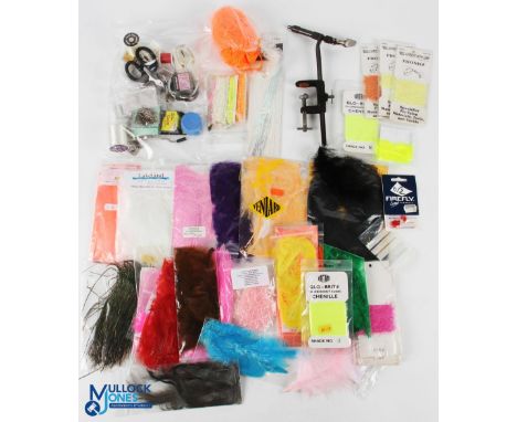 A small fly-tying kit comprising lever vice, bobbin holders, scissors, hooks, beads, thread and varnish, with a selection of 