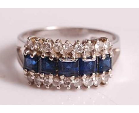 An 18ct white gold, sapphire and diamond three-row half eternity ring, featuring an inner row of five graduated square cut sa