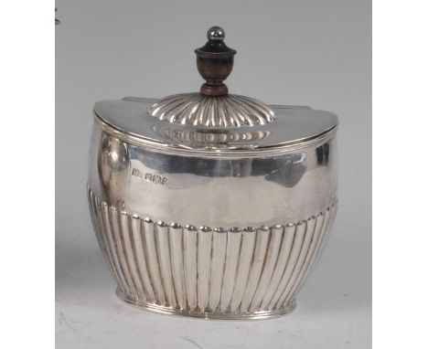 A late Victorian silver tea caddy, of half-reeded oval form, the hinged cover having slightly domed fluted centre surmounted 