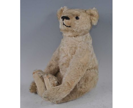 A Steiff vintage teddy-bear, with pale golden mohair, black eyes, black stitched nose, mouth and claws, with felt pads, joint