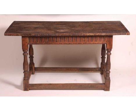 An 18th century joined oak refectory table, of small proportions, having a four plank top with cleated ends, the frieze with 