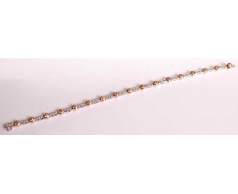 An 18ct white and rose gold diamond line bracelet, comprising seventeen fancy cognac diamonds in rose rubover settings, alter