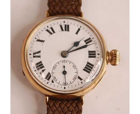 A 9ct yellow gold manual wind trench watch, having a round white Roman dial with subsidiary dial at six, fifteen-jewel moveme