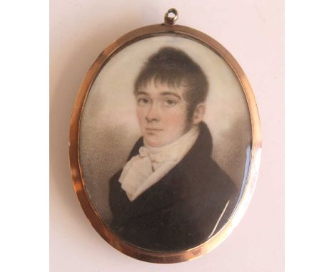A Georgian double-sided portrait mourning locket, one side being a miniature watercolour on ivory depicting head and shoulder