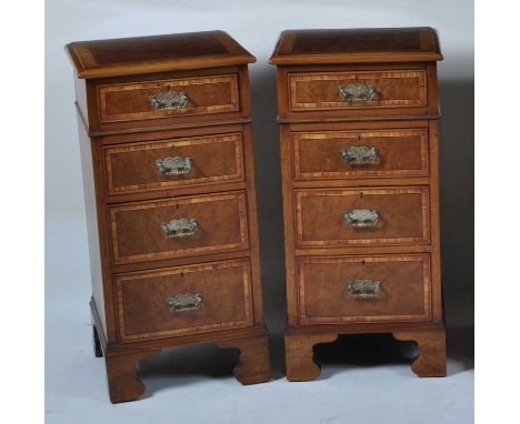 A pair of walnut and figured walnut bedside chests, each having a crossbanded top over four long crossbanded drawers, on brac