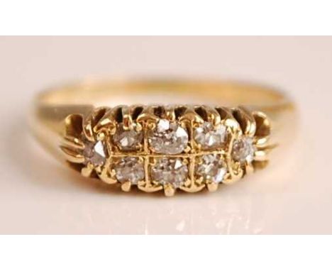 A late Victorian 18ct yellow gold diamond dress ring, comprising a boat-shaped head with eight Old European cut diamonds in s