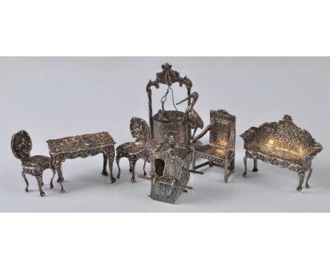 A collection of Edwardian silver dolls house furniture, comprising pair of hall chairs, highback sofa, Wainscot chair, centre