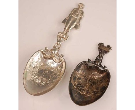 An early 20th century Hanau silver serving spoon, the bowl repousee decorated with dancing figures and scrolling fruit, the s