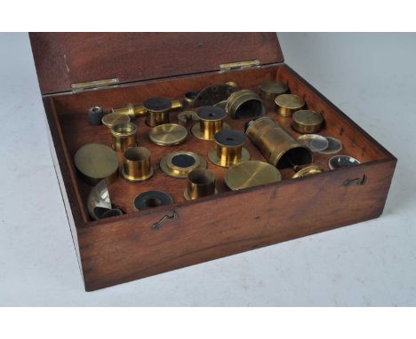 A Victorian mahogany fitted box containing an arrangement of lacquered brass microscope lenses, eye-pieces and accessories, t