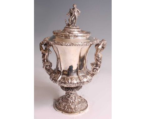 A William IV silver pedestal cup and cover, the cup of fluted campania form, chased and embossed with acanthus leaves, scroll