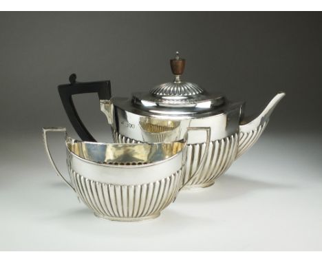 A Victorian silver teapot and sugar bowl, EH, London 1891, each of oval reeded form, the teapot measures 13.5cm high, the sug