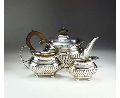 A Victorian three piece silver tea service, Walter & John Barnard, London 1894 & 1895, each piece of oval half reeded form wi