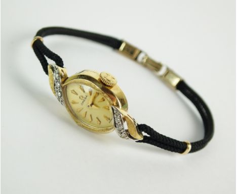 A Lady's Omega diamond set cocktail watch, stamped '14k', the oval champagne dial with batons, diamond set lugs, manual wind,