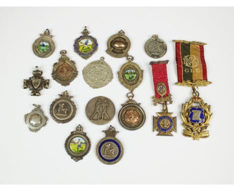 An assorted collection of silver and polychrome enamel medals, together with further silver and white metal examples and two 