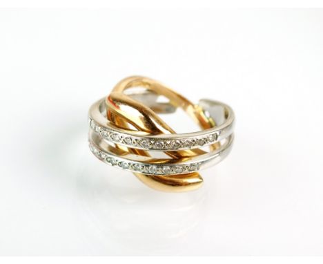 A two row diamond set dress ring, designed as two white metal diamond set bands mounted to a crossover yellow metal band, the
