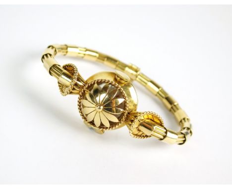 A lady's 18k gold Gubelin cocktail watch, the silvered circular dial with batons and a hinged floral cover, manual wind, the 