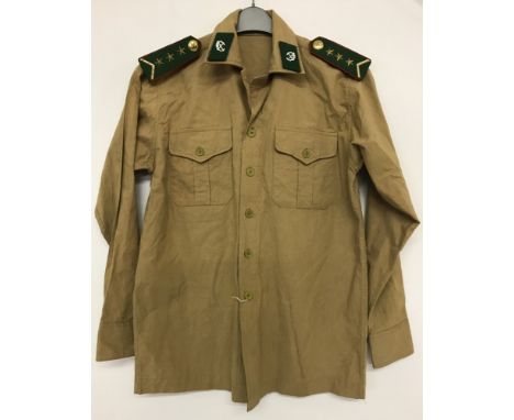 Vietnam War era North Vietnamese Infantry NCO's shirt in dry season beige cotton. With green, red and gold shoulder boards an