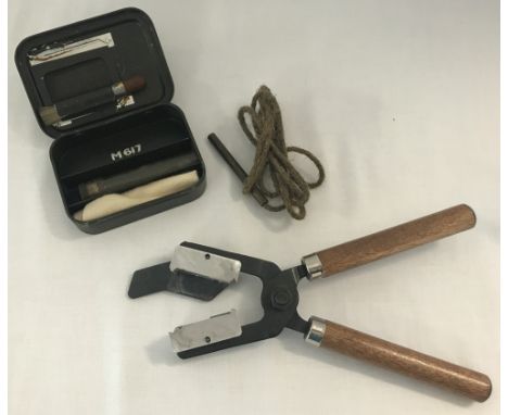 A handheld gun shot mould together with a M617 revolver cleaning kit.  