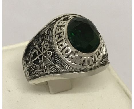 A white metal Special Forces ring set with central oval green stone.  Ring size Y.