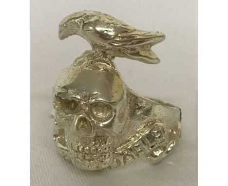 A white metal "Expendables" ring with skull and raven design.  Ring size X.