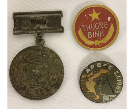 2 Vietnam War Era N.V.A/Vietcong badges and a medal found in a street market in Saigon. North Vietnamese Army War Veteran bad