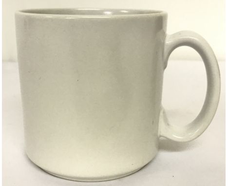 A WW2 style German white ceramic mug. With eagle motif stamped to base. Approx. 9.5cm tall x 9cm diameter.