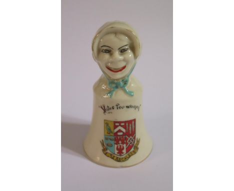 A Carmen China Suffragette 'Votes for women' Crested Ware SEASCALE Bell, the finial with an 'ugly' and 'pretty' head with the