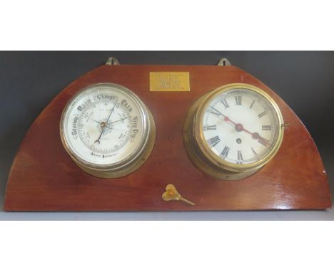H.M.S. EXETER (attrb.) Brass Ship's Bulkhead Clock with 7" dial and aneroid barometer by John Boyce,  mounted on wooden panel