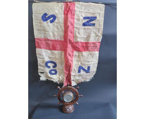 A New Zealand Shipping Company 'Ship's Wheel' Aneroid Barometer 29cm and flag 