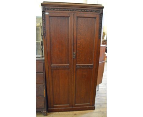 A chest of two short and three long drawers, a wardrobe and wooden decorative hanging shelves