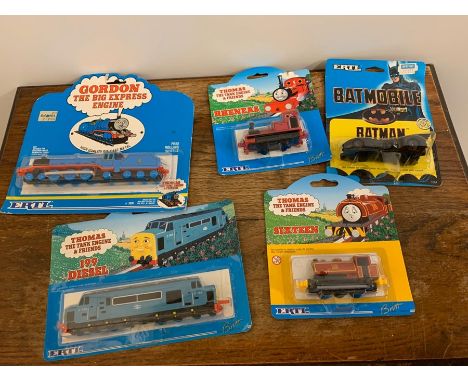 Five diecast Thomas the Tank Engine trains and a batmobile 