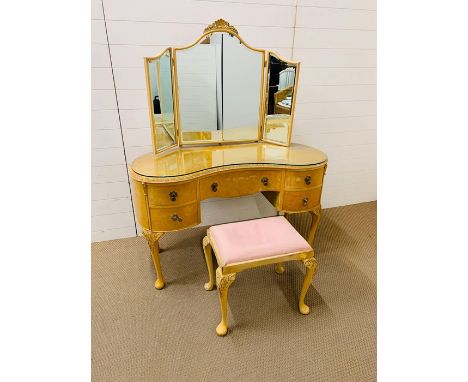 A kidney shaped five drawer dressing table with mirror and stool 