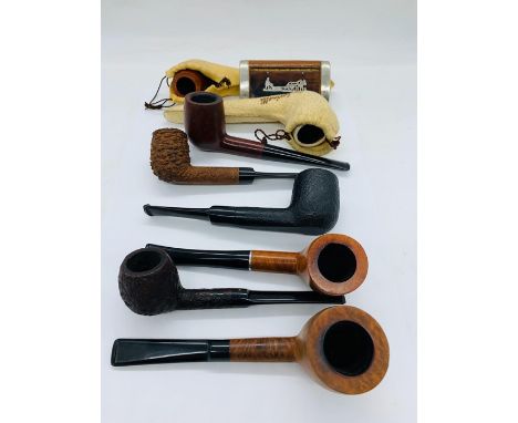 A selection of eight collectable pipes one with an 18 K gold mount.