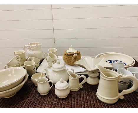 A mixed selection of white pottery to include, cups and saucers, serving bowls, milk jugs, teapot etc