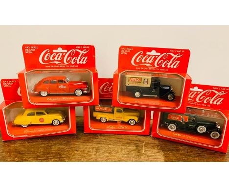 Five boxed Coca Cola diecast model cars 