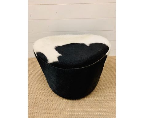 A faux cowhide foot stool