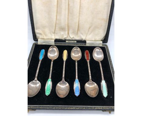 A boxed set of silver and enamel spoons in an Art Deco style, makers mark HCD and hallmarked Birmingham 1950.